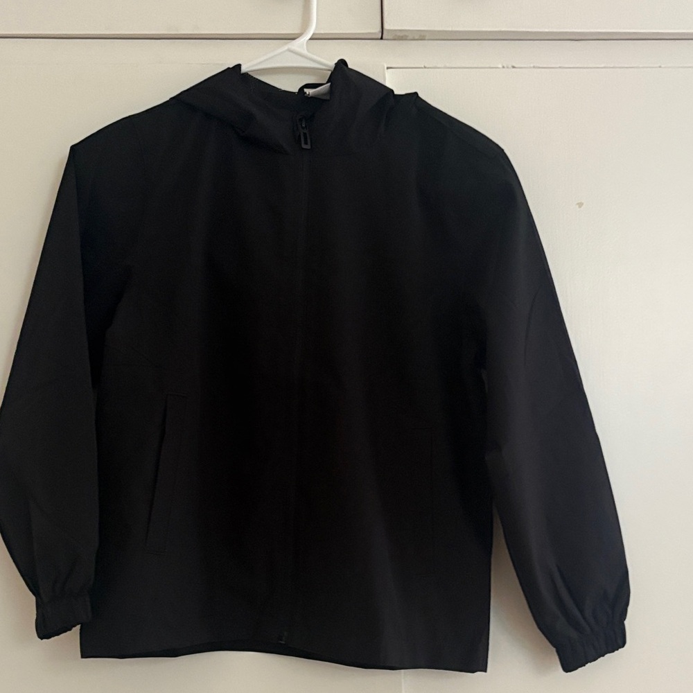 Black Hooded rain jacket 9-10 - never worn but no tags. Home smoke and pet free